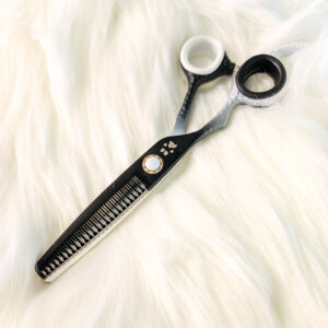 Professional dog grooming thinning shears with black handle and textured blade